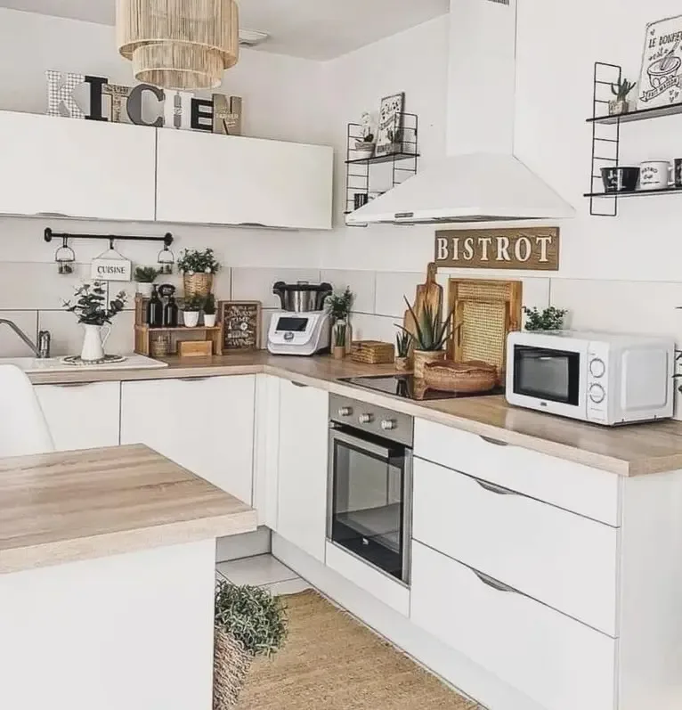 White kitchen with brass hardware and stone countertops